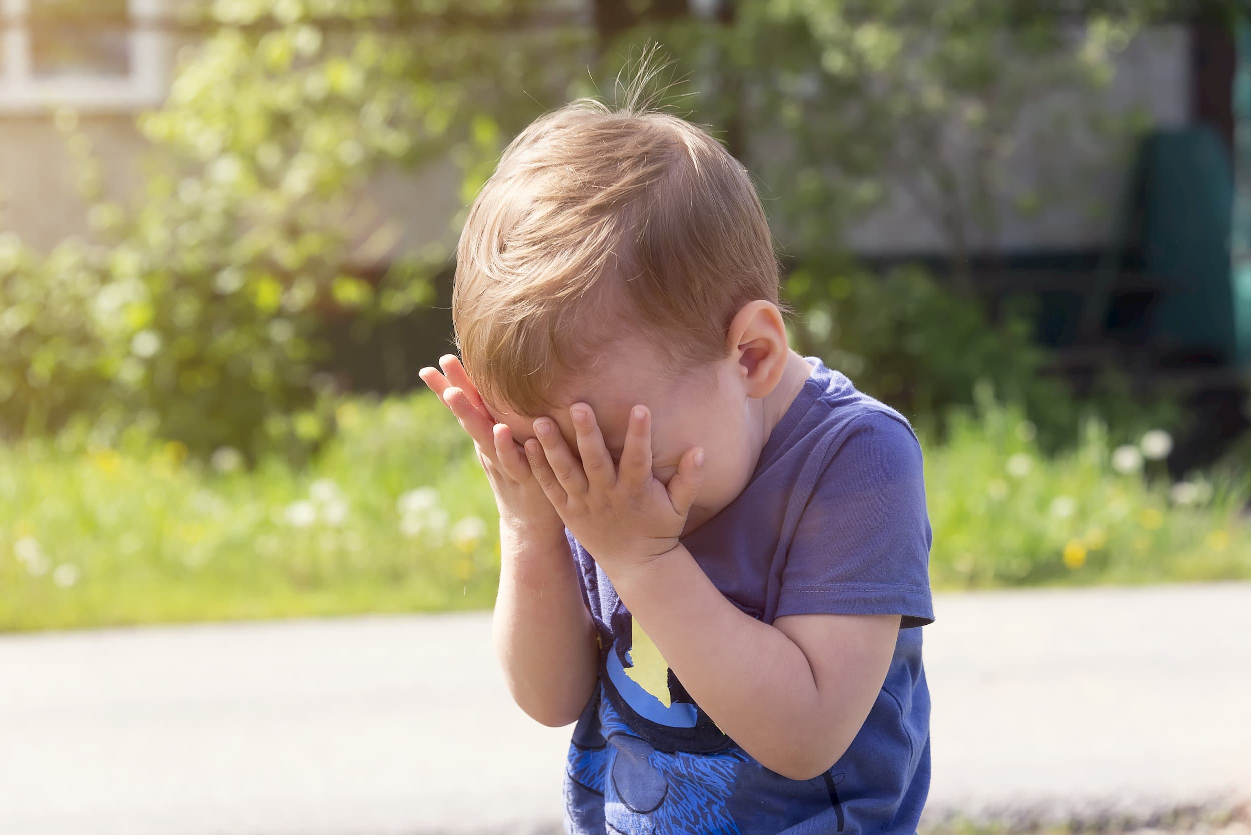 Young boy with face in his hands