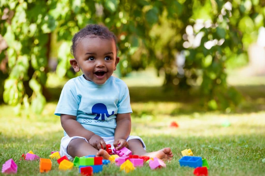 African american baby boy playing in the grass
