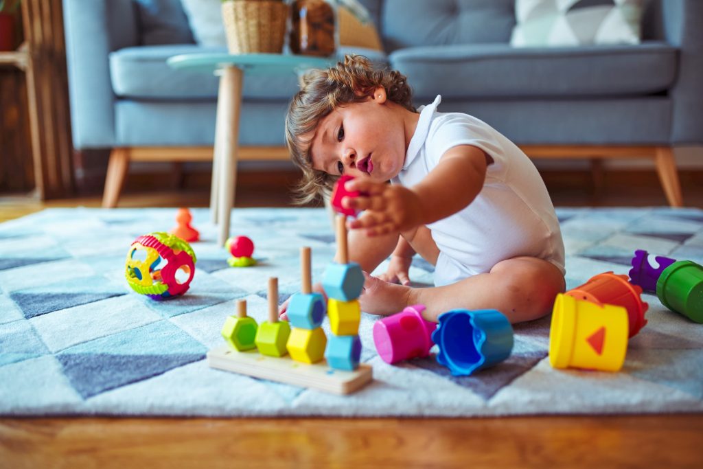 Young child playing with building block
