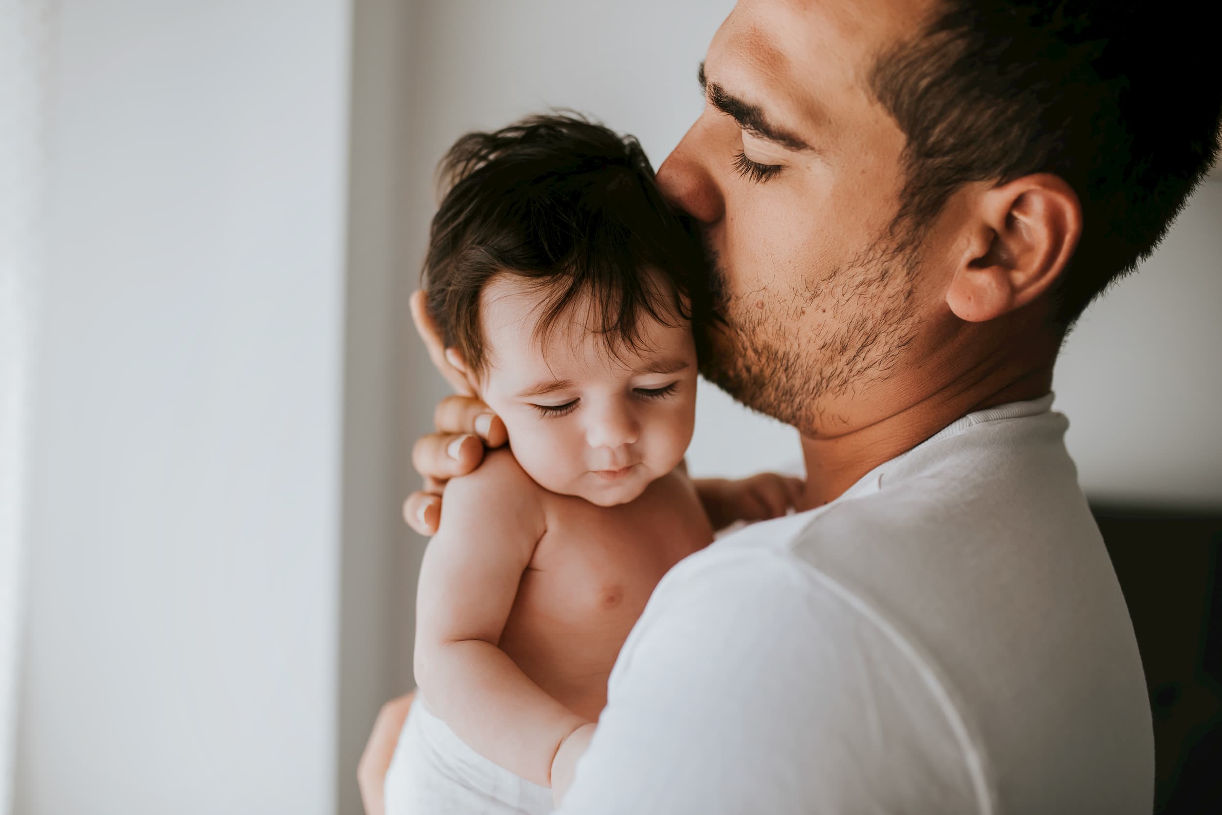 Father kissing his baby on the cheek