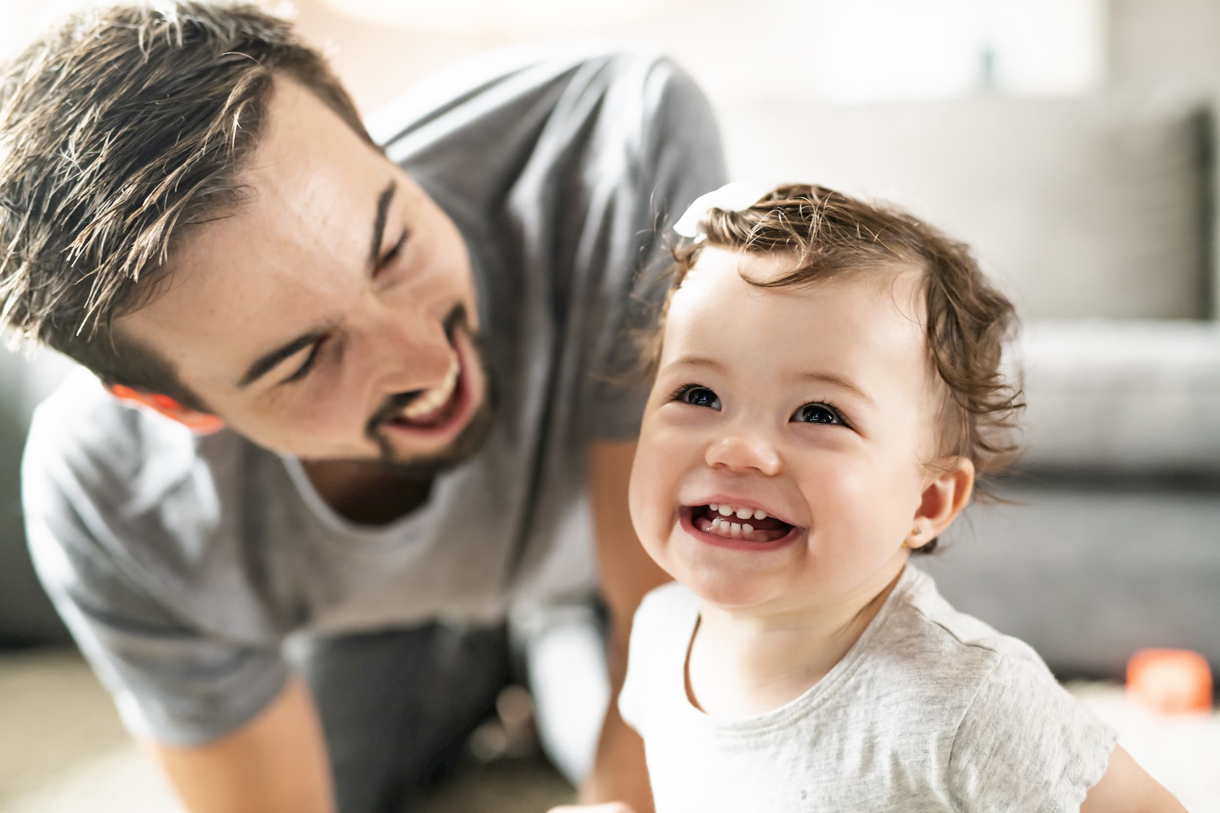 Father and baby smiling