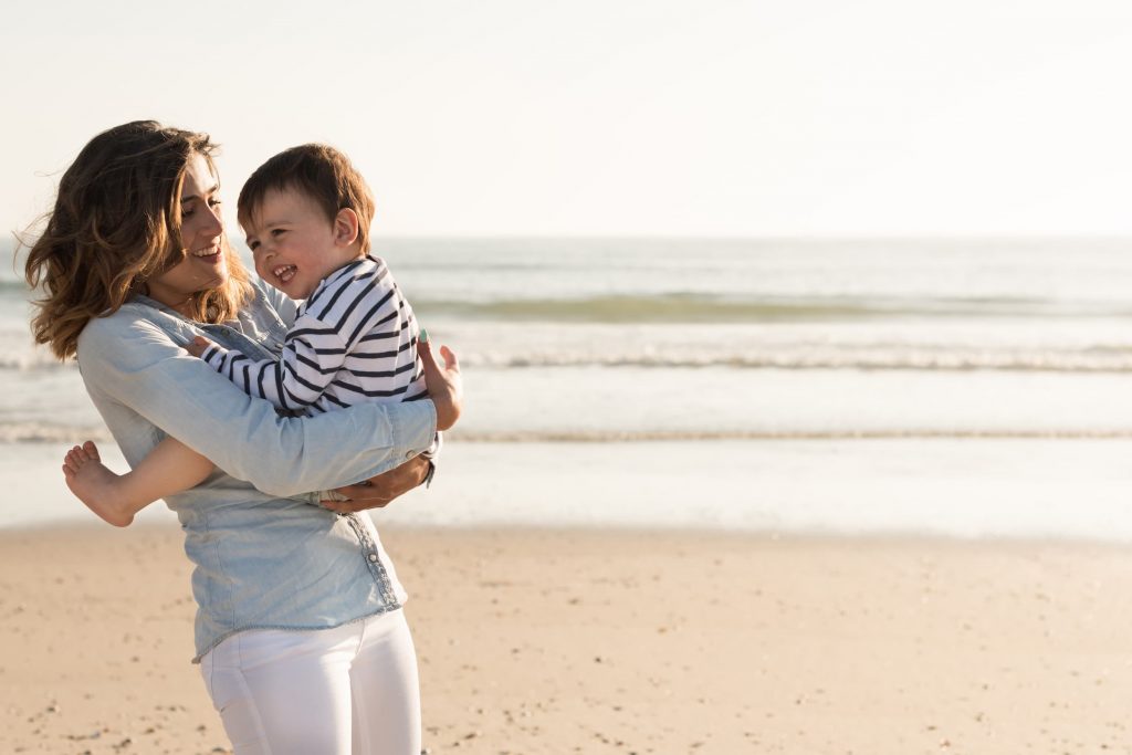 Happy mother and child at the beach