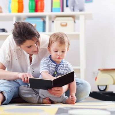 Happy mother playing with baby boy at home Happy mother playing with baby boy