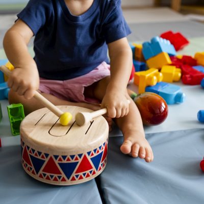 Child banging on a drum